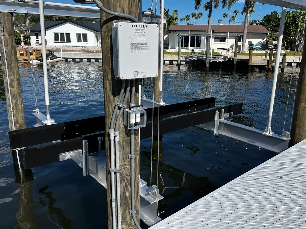 Boat lift control box, disconnect and conduit wiring installed on a dock piling in Pinellas County, FL