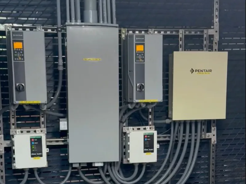 Commercial pool pump room with heaters and automated chemical feeders