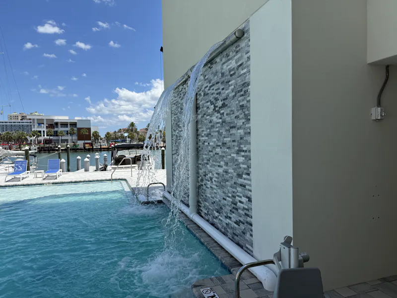 Lit water feature with submersible pumps and synchronized display controls